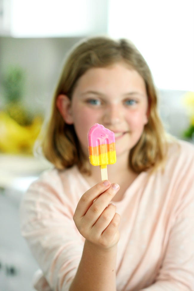 child holding finished candy popsicle