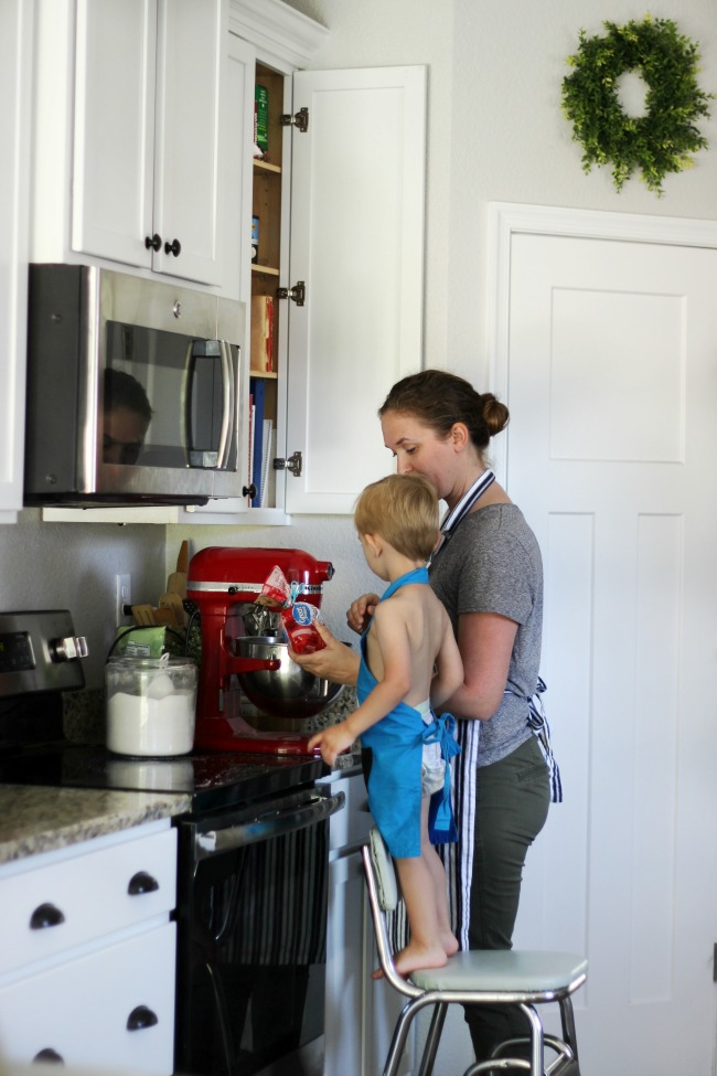 mom and toddler baking cookies