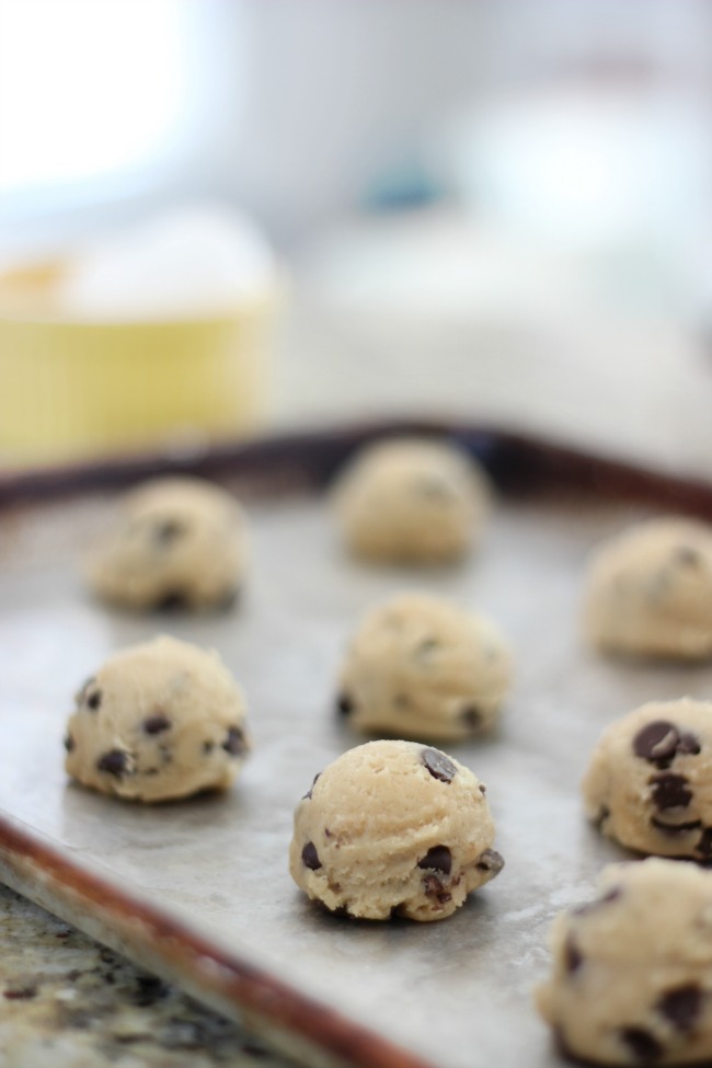 frozen cookie dough balls on baking sheet