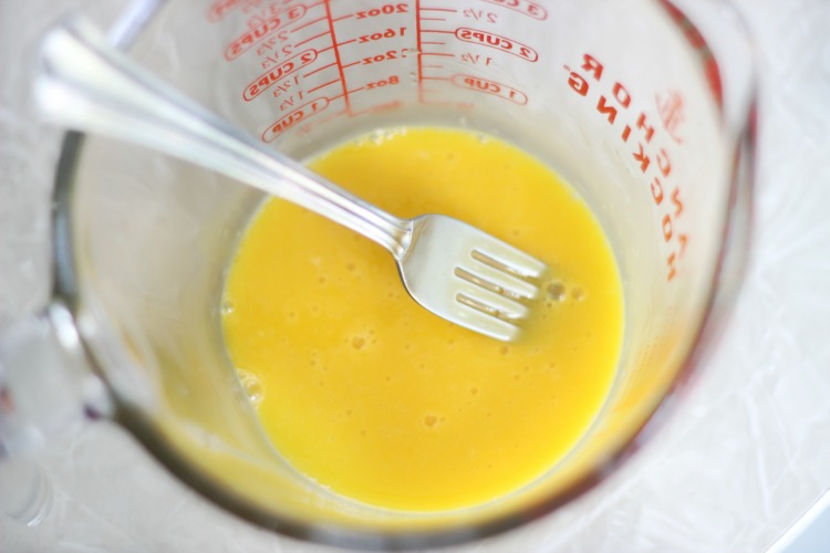 measuring cup with beaten eggs