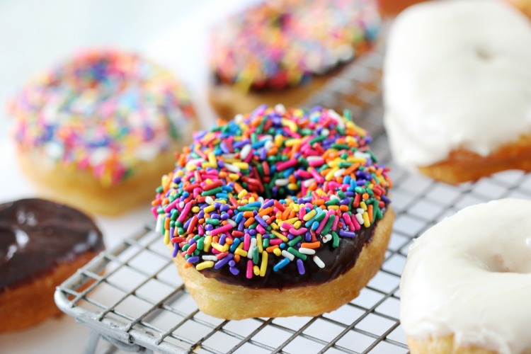  biscuit dough donut with sprinkles on cooling rack