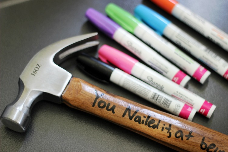 hammer on table with oil based paint pens