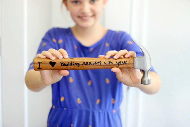 child holding diy personalized hammer that says "I (heart) building memories with you!"