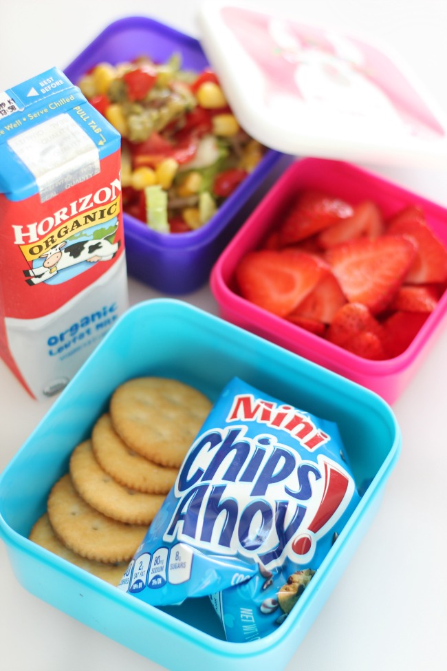 lunch containers with cookies and crackers, strawberries and milk box