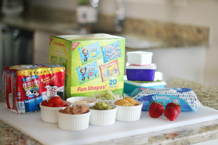 lunch items on counter: milk cartons, crackers and cookies, strawberries