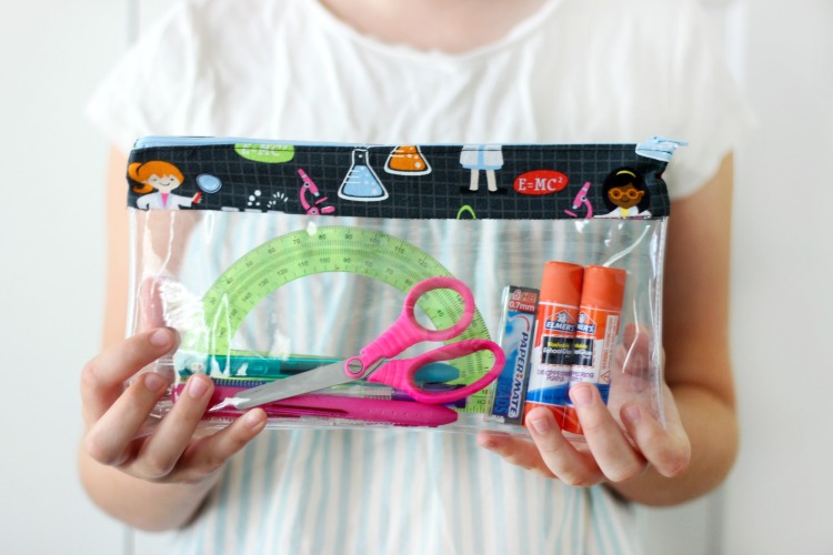 A simple vinyl pencil pouch tutorial with step-by-step photos for making a 10" x 6" pouch for school or travel! Customize with colorful fabric and a zipper.
