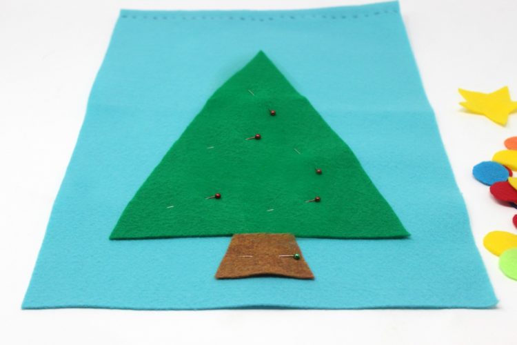 blue felt with green triangle and brown rectangle for tree and tree trunk