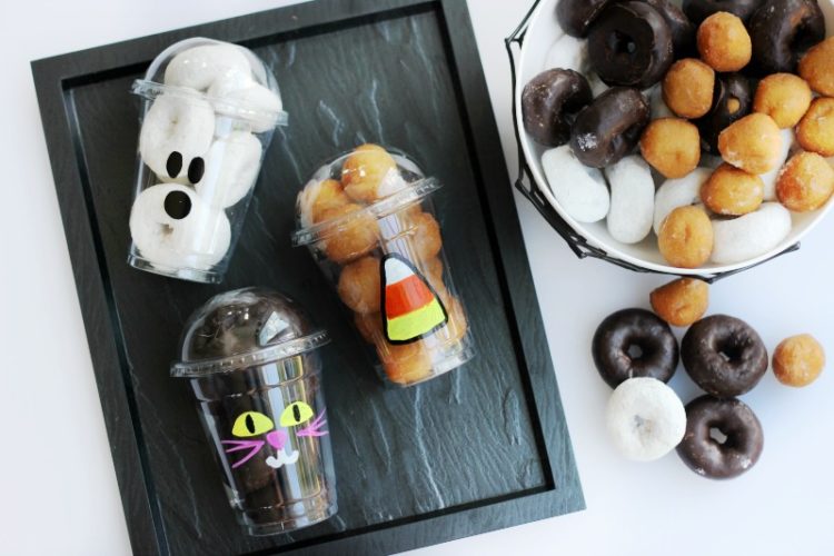 black platter with 3 cups of halloween donut cups