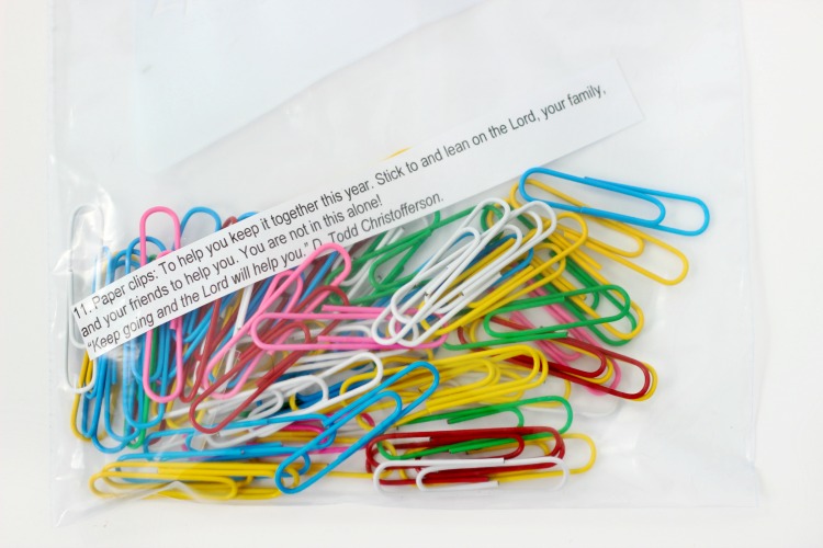 baggie of paper clips with printed quote inside
