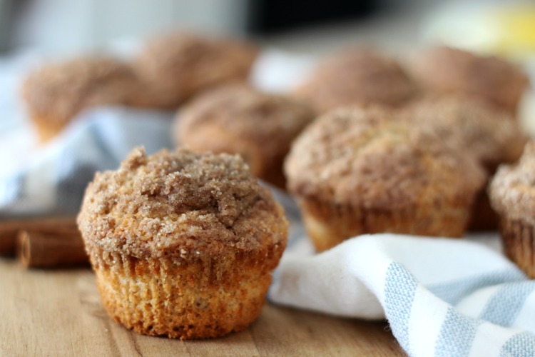 apple cider muffins on cutting board with hand towel