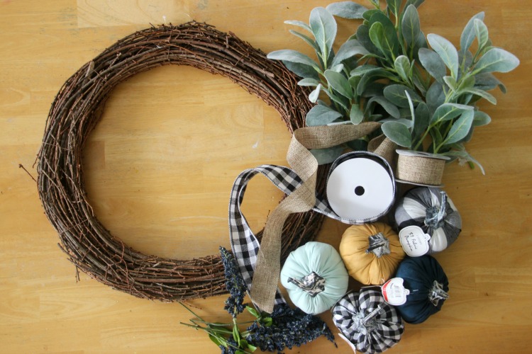 supplies for dollar spot pumpkin wreath: grapevine wreath base, $1 pumpkins, lambs ear greenery, ribbon