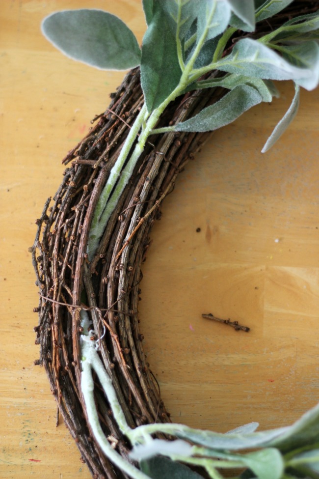 grapevine wreath with stems tucked in between vines