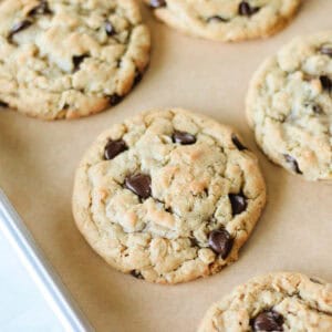 Baking sheet of oatmeal chocolate chip cookies on baking sheet with parchment paper.