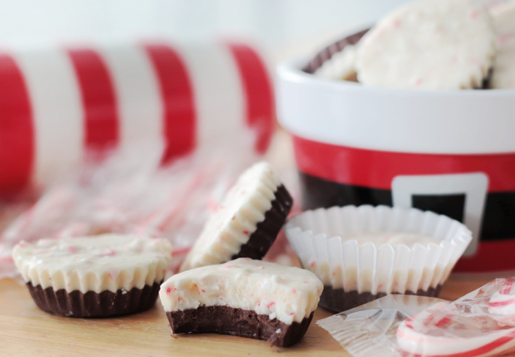 Ghirardelli peppermint bark cups on table. One with bite out of it.