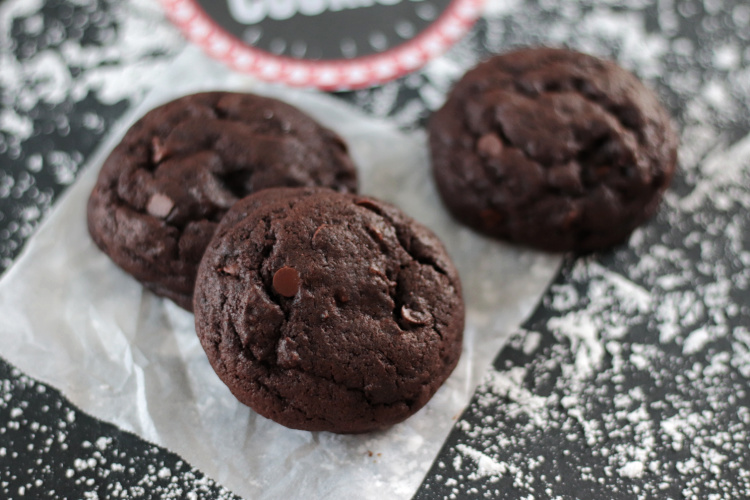 two double chocolate cookies on parchment paper