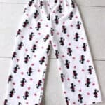 White pajama pants with black dogs on the front.