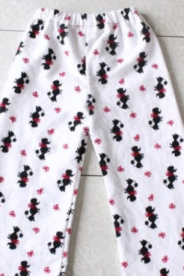 White flannel pajama pants with black dogs on the front.