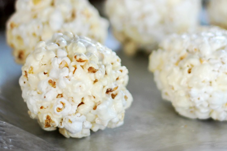 marshmallow popcorn balls on baking sheet