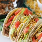 4 tacos standing up on plate