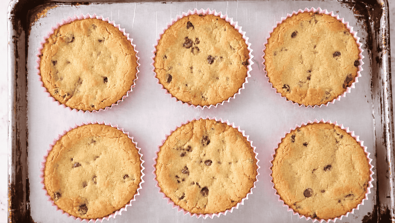 Baked deep dish cookies on baking sheet.