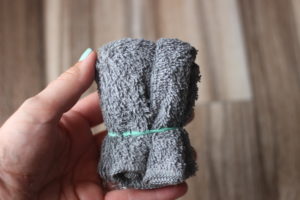 wash cloth tied with rubber band
