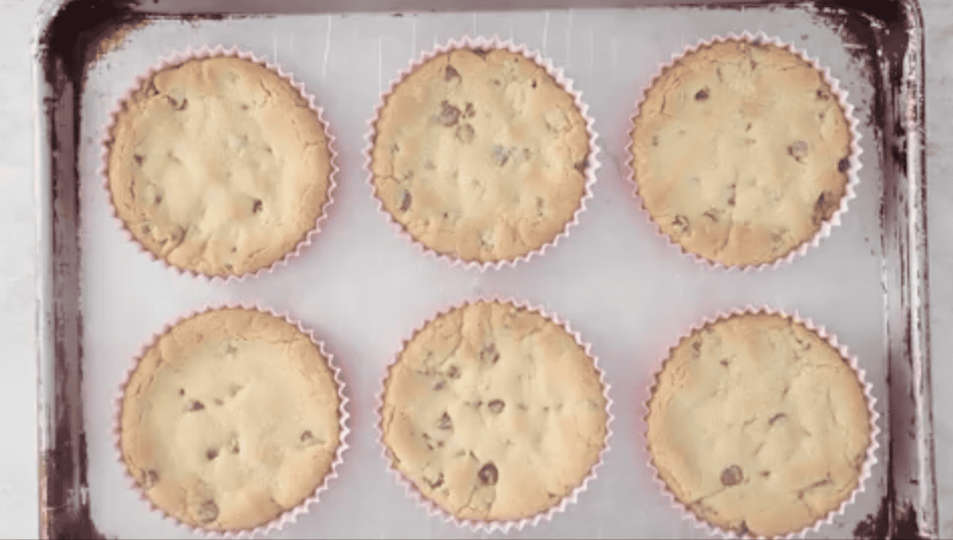 Baking sheet of baked deep dish chocolate chip cookies.