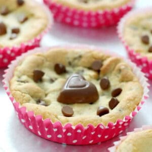 Deep dish chocolate chip cookies in pink baking liners.
