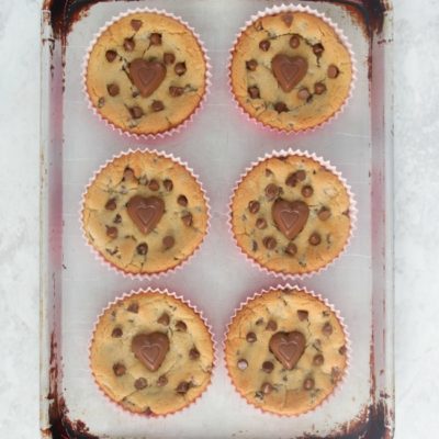 giant chocolate chip cookies on baking sheet