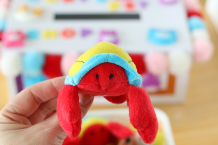 hand holding mini plush crab toy 