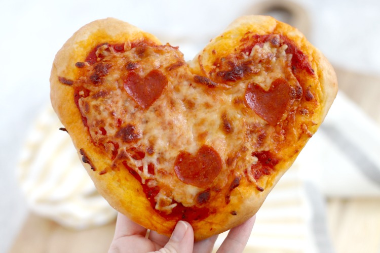 mini heart pizzas held in hand