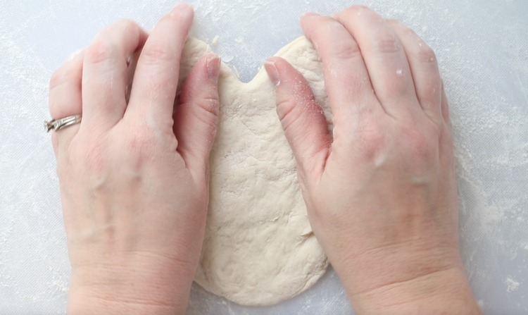 shaping pizza dough into a heart shape