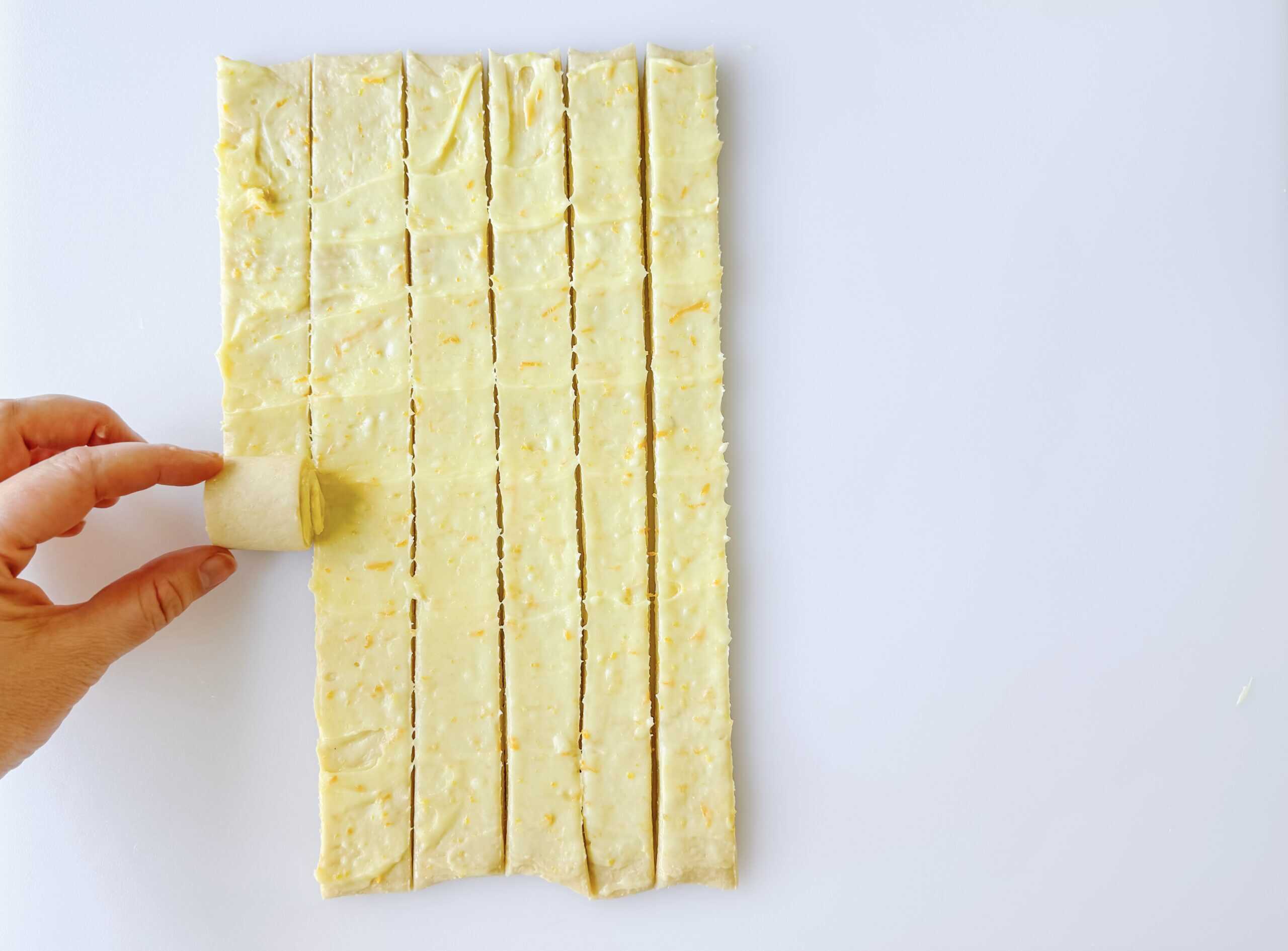 Sweet roll dough cut into strips and rolled into rolls.