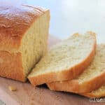 Sliced Amish white bread on cutting board.