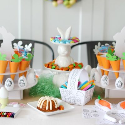 crafty easter tablescape with bundt cake on plate, diy paper easter baskets and diy easter eggs