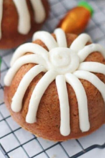 Mini carrot bundt cakes on wire cooling rack.