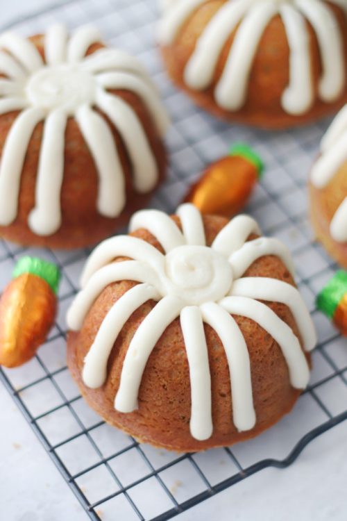 mini frosted bundt cakes on cooling rack