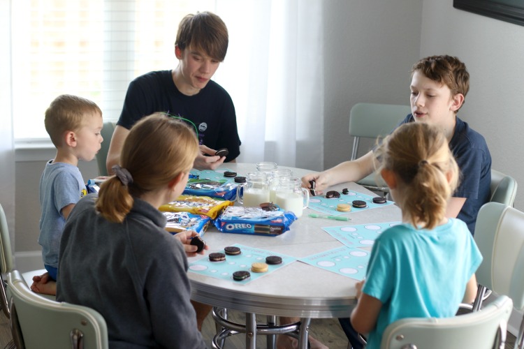 kids sitting at table trying different flavors of oreos