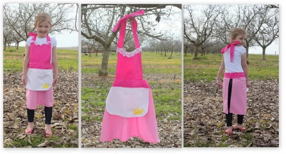 Little girl wearing Aurora apron.