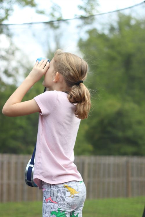 child looking through binoculars