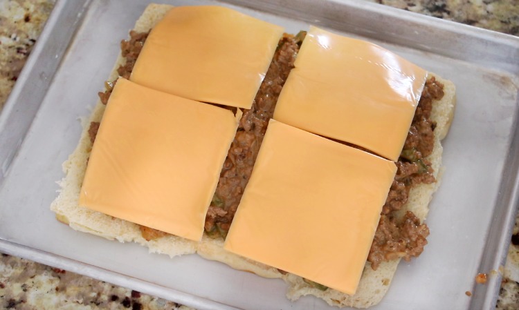 rolls with cheesesteak filling and cheese on top