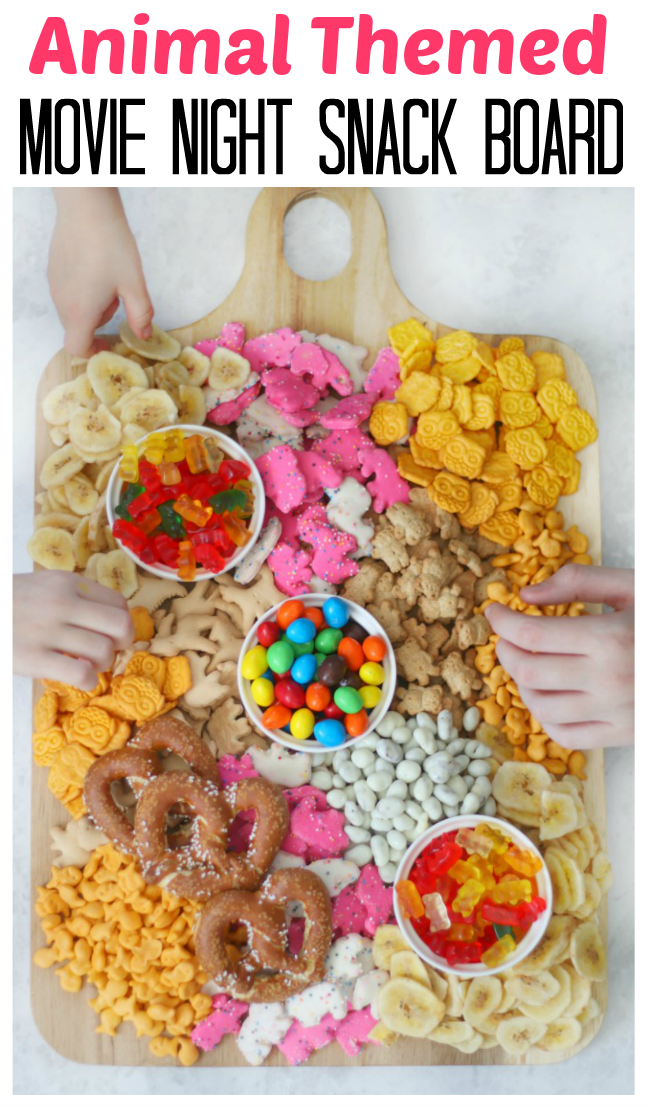 hands selecting snacks from animal movie night snack board