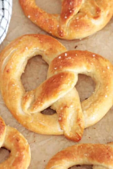 Soft pretzels on parchment paper.