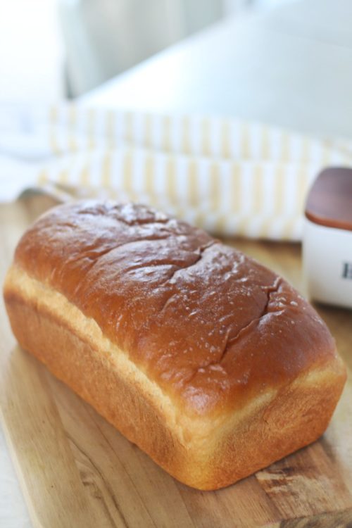 loaf of honey wheat bread on cutting board