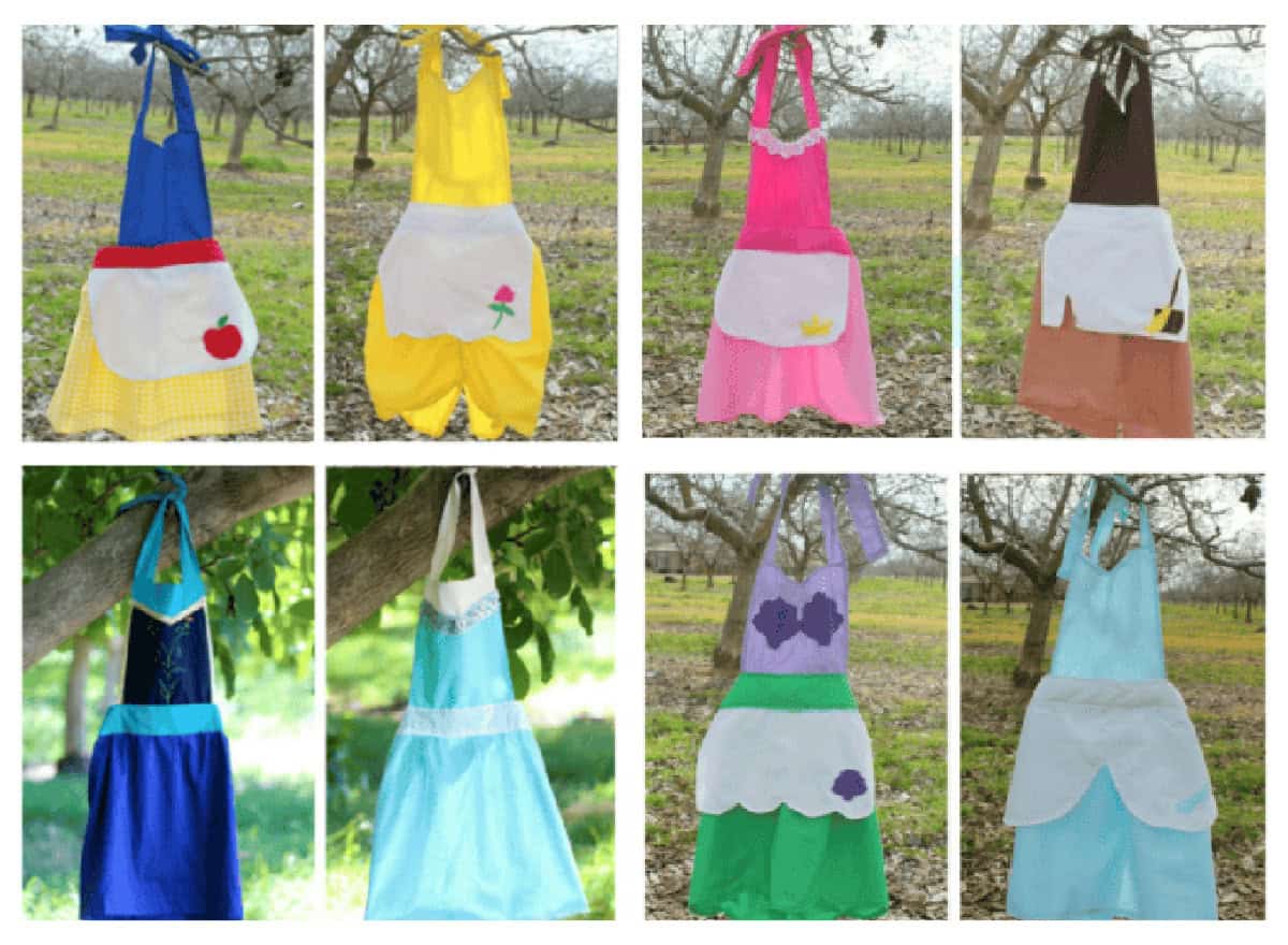 8 princess aprons hanging from trees.