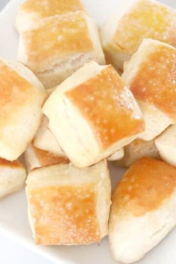 Butter and salt pretzel bites on white plate.