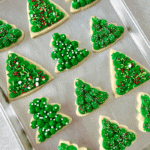 baking sheet of green christmas tree sugar cookies