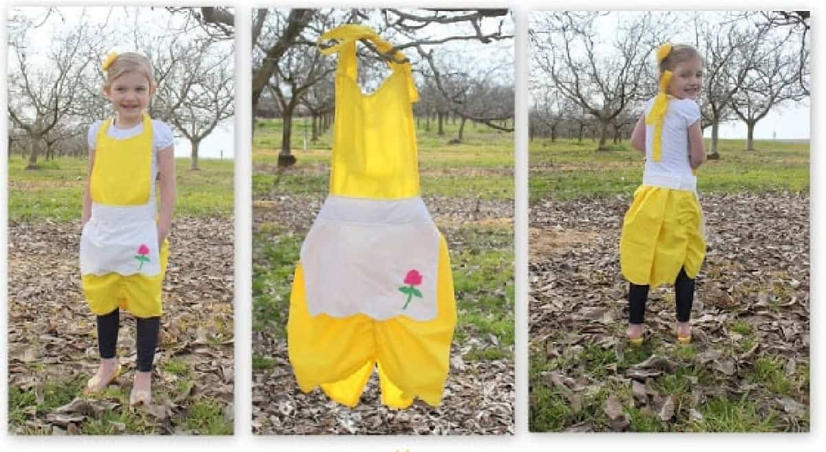 Little girl wearing Belle apron.