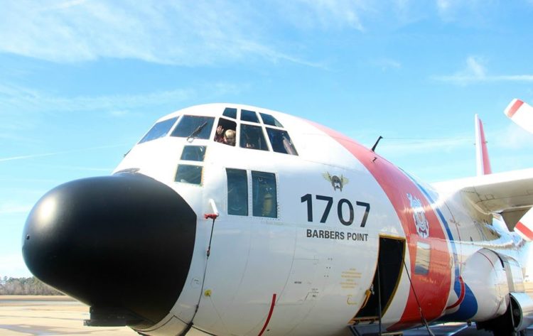 coast guard airplane outside with child waving from the window