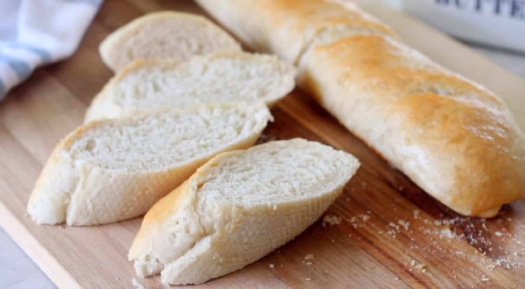 Sliced French bread on cutting board.
