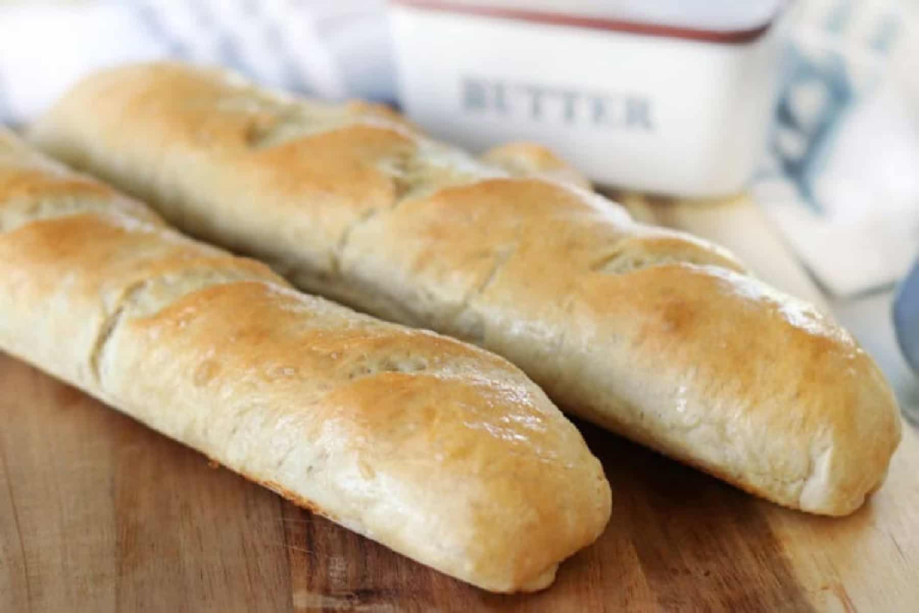 Two loaves of French bread on cutting board.